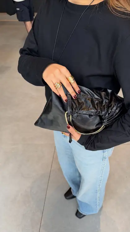 Anuncio de Abbárt en Instagram: mujer con un bolso de cuero negro.